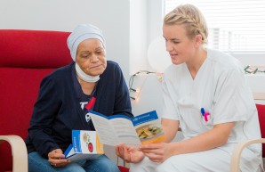 an inpatient and a nurse looking at a flyer